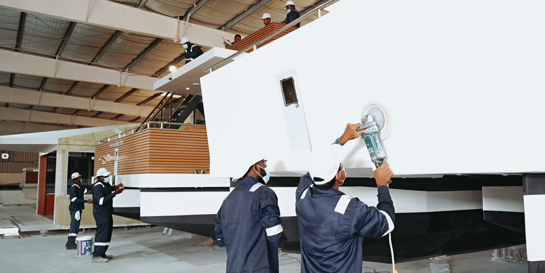 V-Marine technicians polishing a RISE hull inside the Bahrain factory