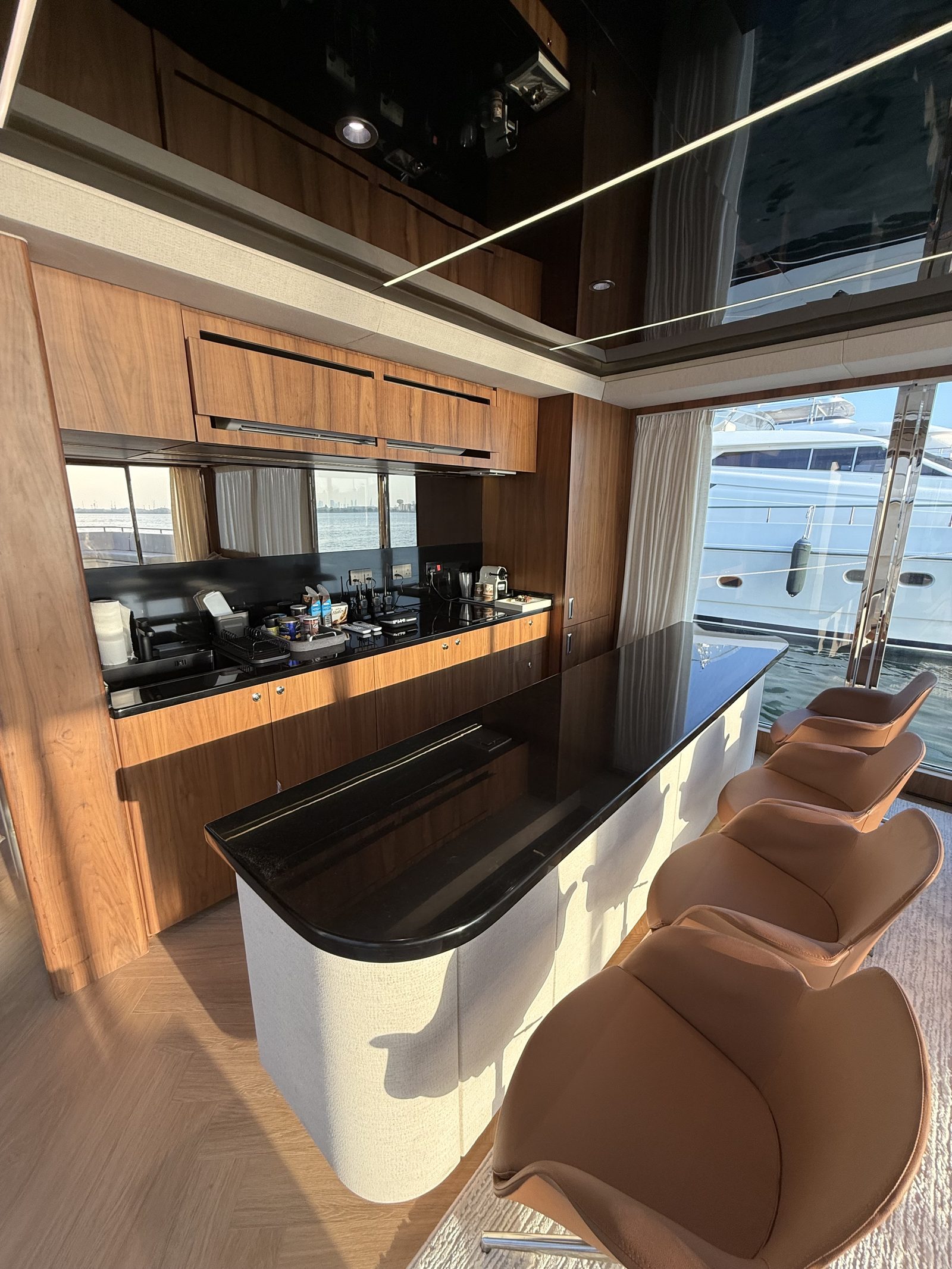 RISE 70 galley with timber joinery, black countertops and sea views