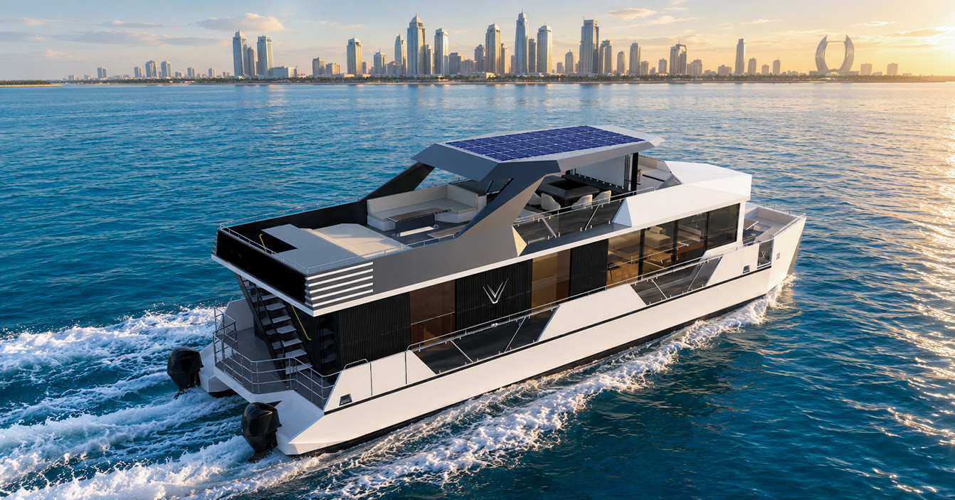 RISE 70 GRP V-CAT catamaran cruising at sunset with a city skyline behind